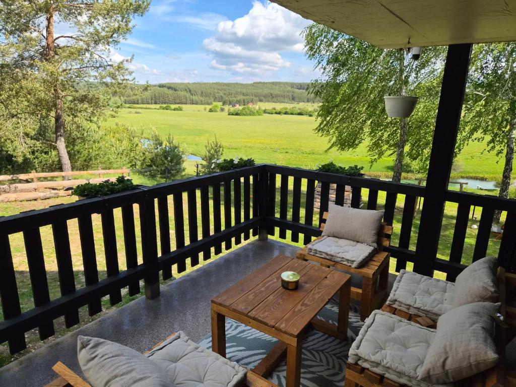 a porch with two chairs and a table and a table at Danka Riverside House in Livno