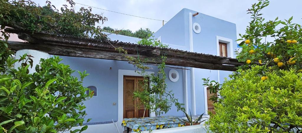 a white house with trees in front of it at Casa del Limone in Filicudi