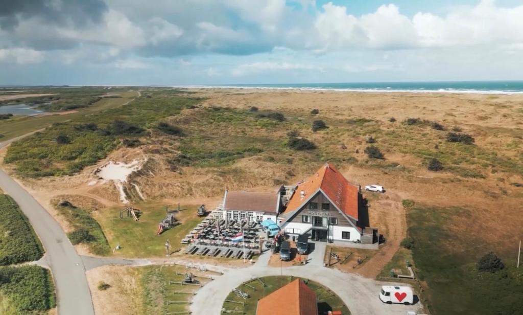 an aerial view of a house on a beach at Hotel Posthuys Vlieland in Oost-Vlieland