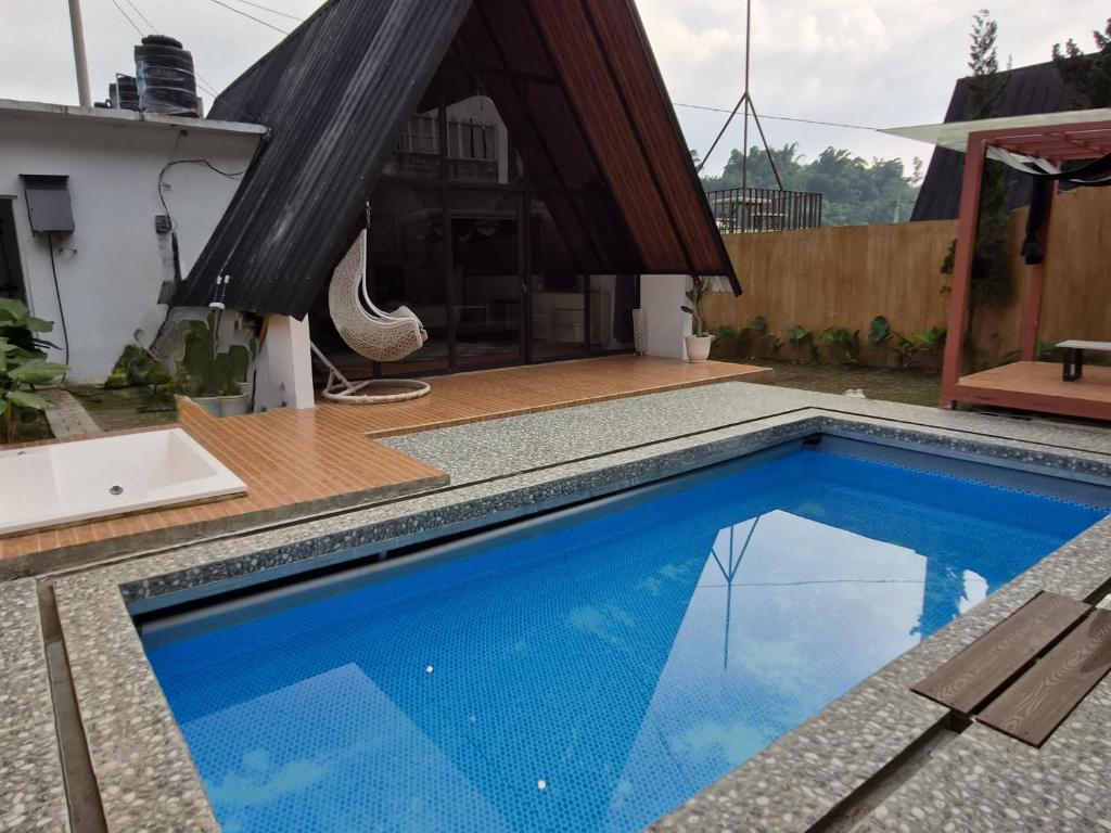 a swimming pool in the backyard of a house at Aira Private Pool Glamping in Bandung