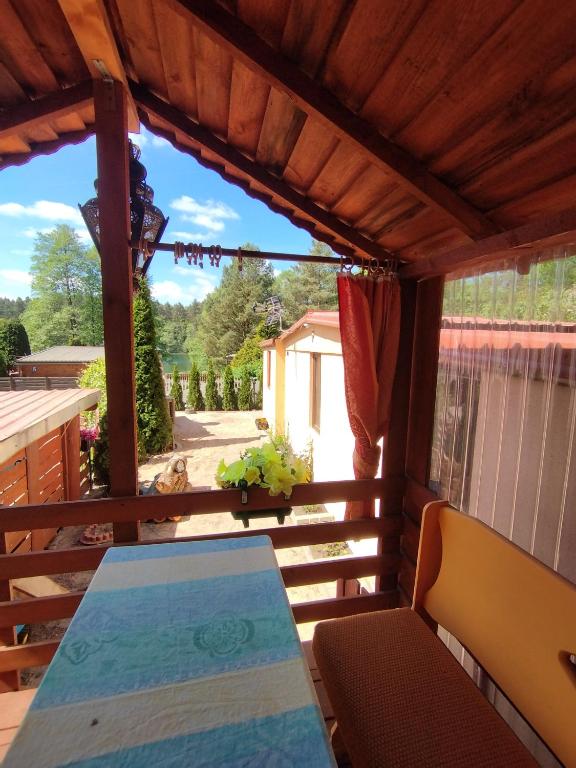 a view from the porch of a house with a table and chairs at Betlejem Nad Jeziorem in Gostyczyn