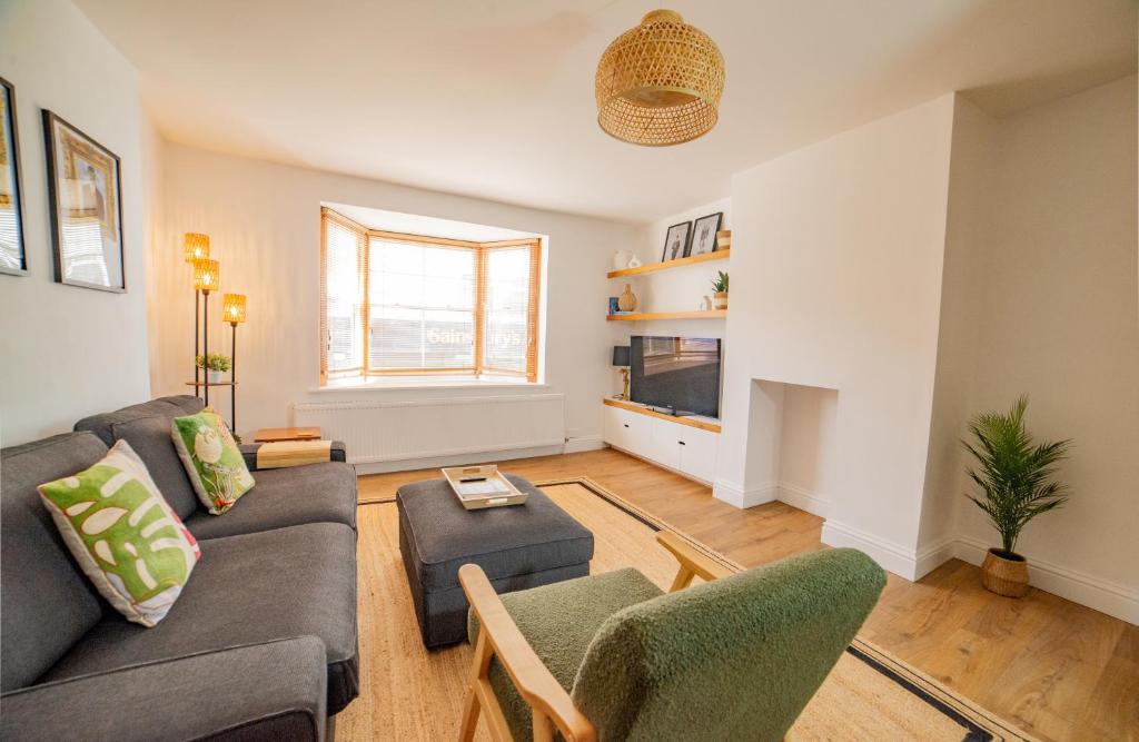 a living room with a couch and chairs at High Street Retreat in Whitstable