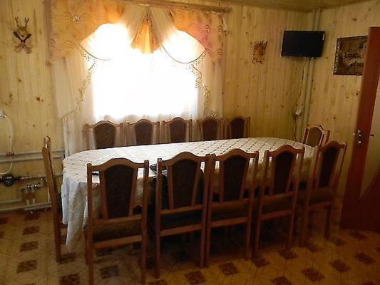 a room with a table with chairs and a window at U Karoliny in Yaremche