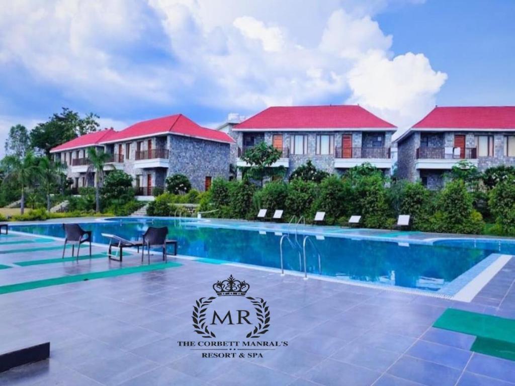 a view of a resort with a swimming pool at The Corbett Manral Resort in Rāmnagar