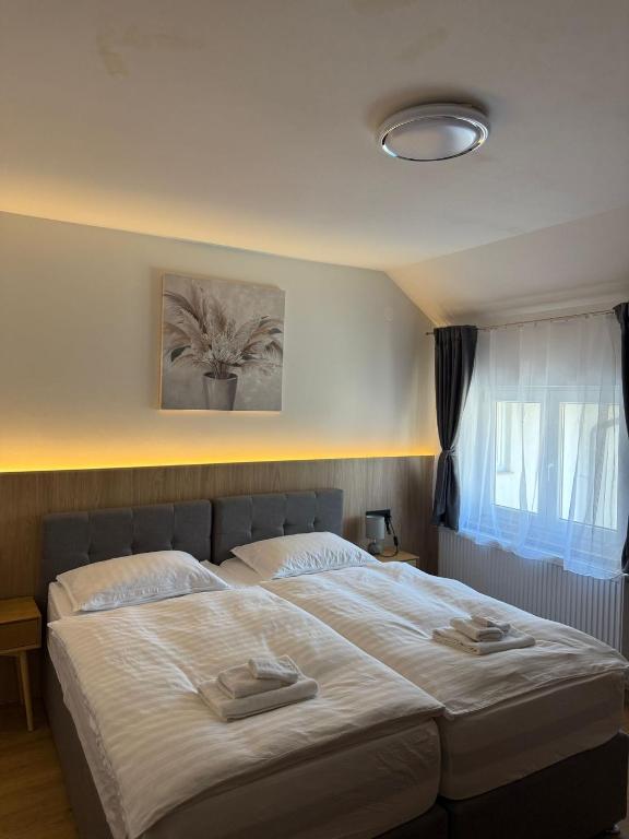 a bedroom with a large bed with two towels on it at Gaja in Križpolje