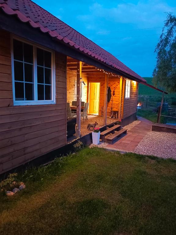 a small house with a patio in the yard at Przystanek Natura in Radzie