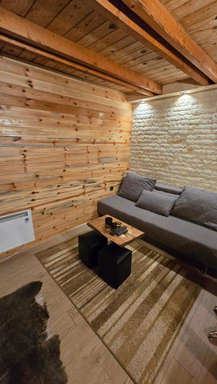 a living room with a couch and a table at Star Cottage in Bajina Bašta