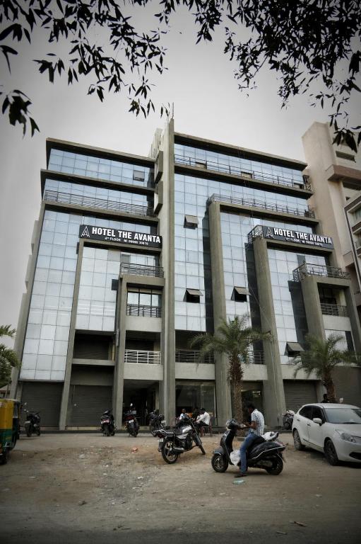a large building with motorcycles parked in front of it at Hotel The Avanta- Naroda in Naroda