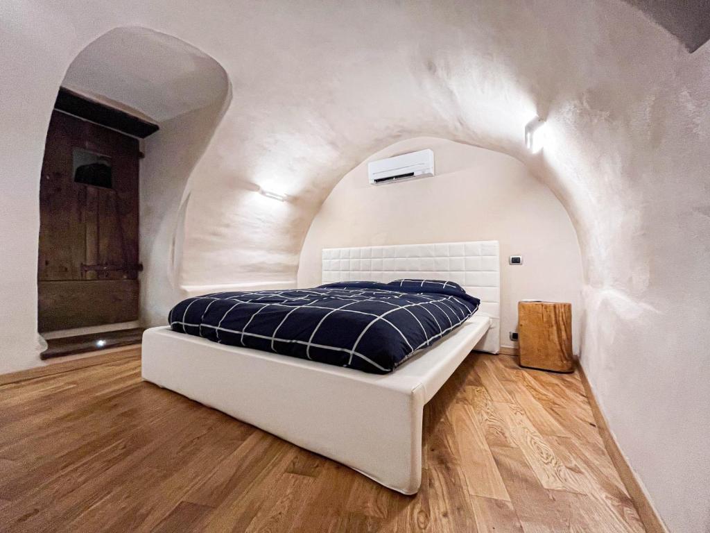 a bedroom with a bed in a white room at Dal Ciavatin in Paesana
