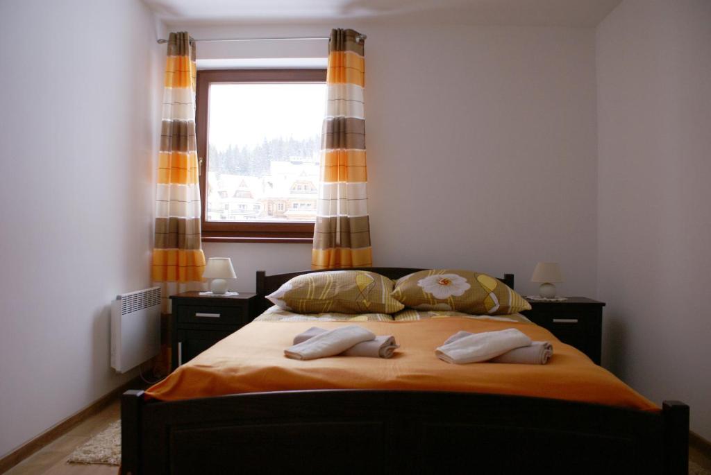 Posteľ alebo postele v izbe v ubytovaní Apartament Słoneczny Koscielisko