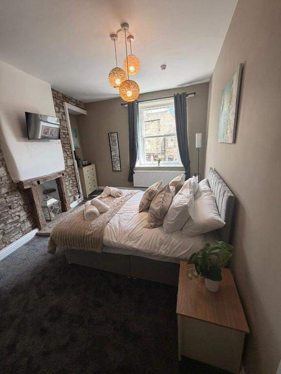 a bedroom with a large bed and a window at The Crown in Hawes