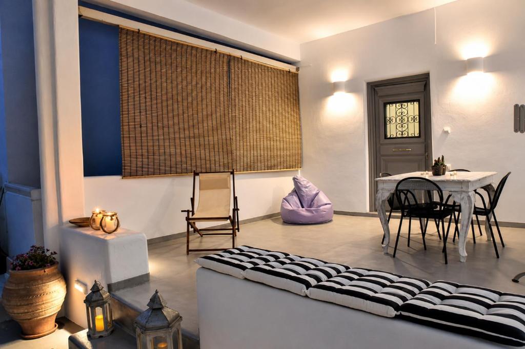 a living room with a table and a dining room at Mare Bay in Adamantas