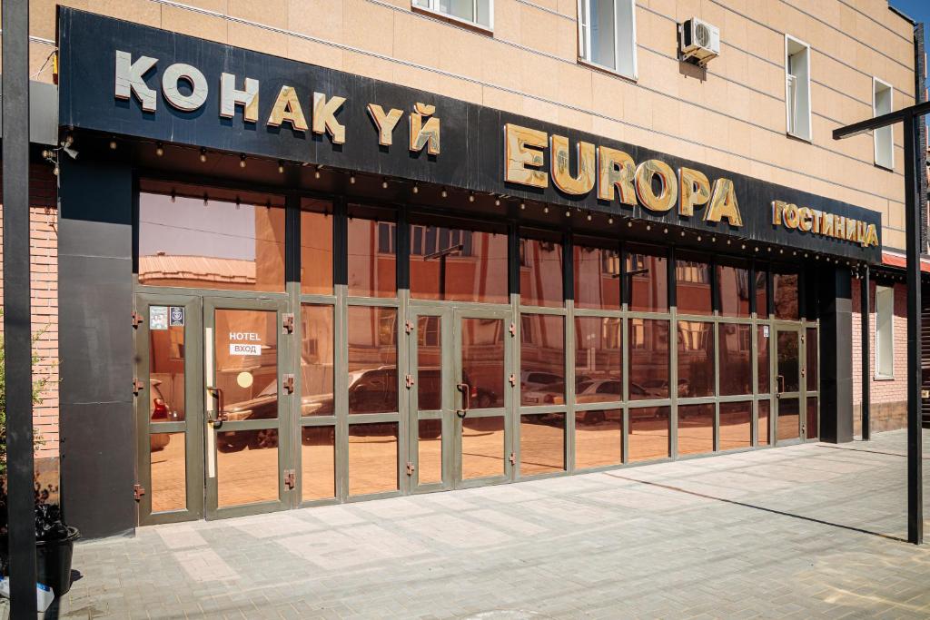 a store front with doors open on a building at EUROPA Hotel in Semey