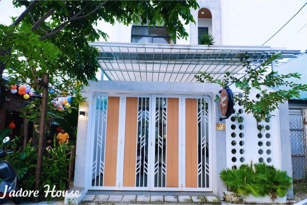 a front door of a house with an american flag at Jadore House in Danang