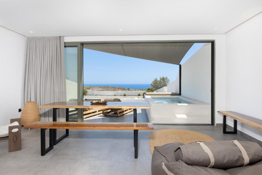 a living room with a table and a couch at Acro Caldo Suites in Akrotiri