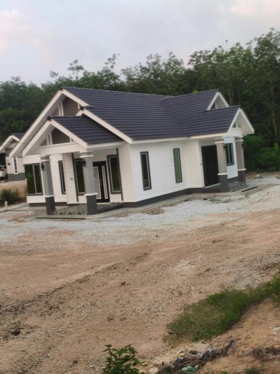 a house with a solarium on top of it at D'Jawa Homestay in Baling