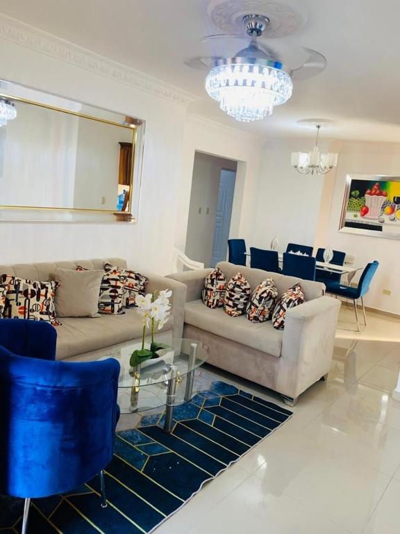 a living room with a couch and blue chairs at Apartment Ñ4 in La Grúa