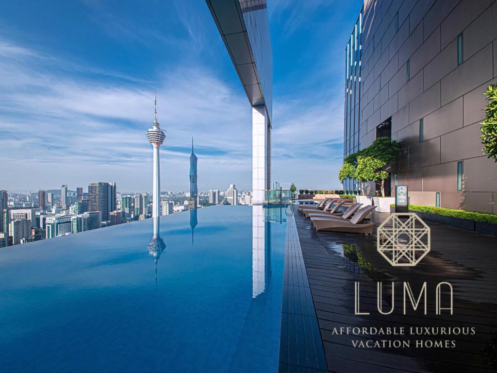 a swimming pool on top of a building with a city at The Platinum Kuala Lumpur by LUMA in Kuala Lumpur