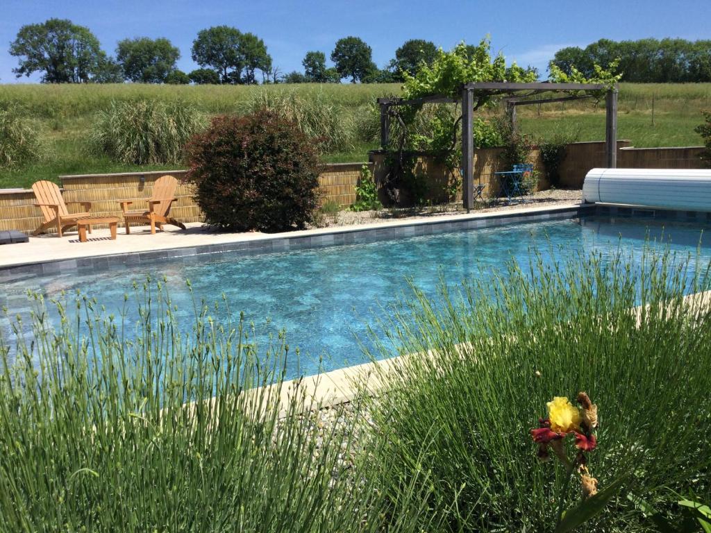 a swimming pool in the middle of a yard at Chambre d’hôtes de La Plano in Saint-Jean-de-Marcel