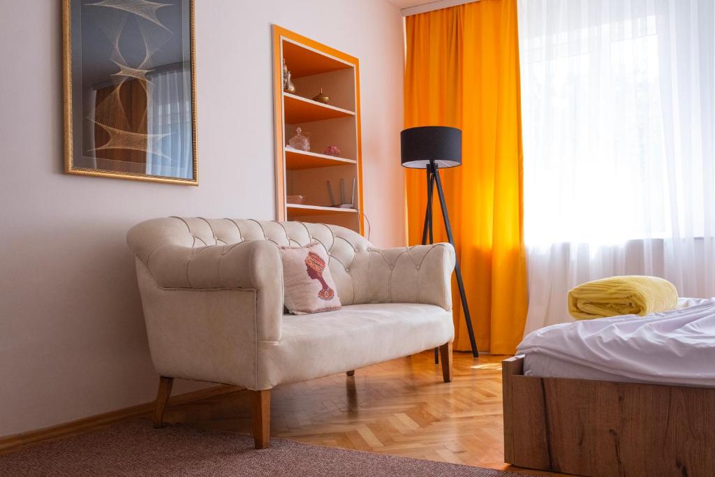 a living room with a chair and a bed at Rron's House in Prizren