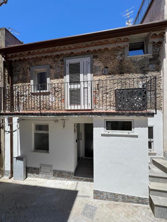 a building with a balcony on the side of it at "DOMUS LEONE" - Nel Borgo di Capri Leone in Capri Leone