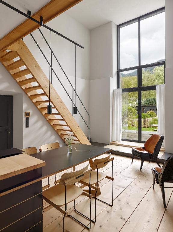 a kitchen and dining room with a table and chairs at berge I Design-Quartiere in Aschau im Chiemgau