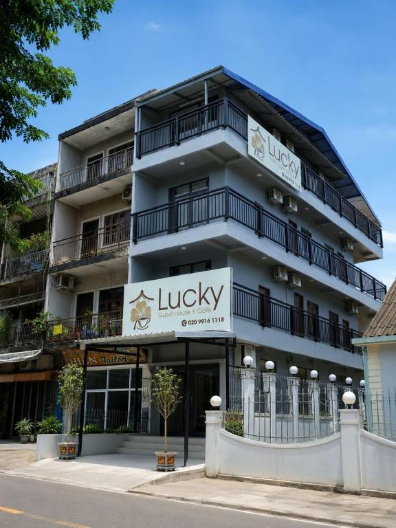 a large building with a sign that reads lucky at Lucky Hostel in Vientiane