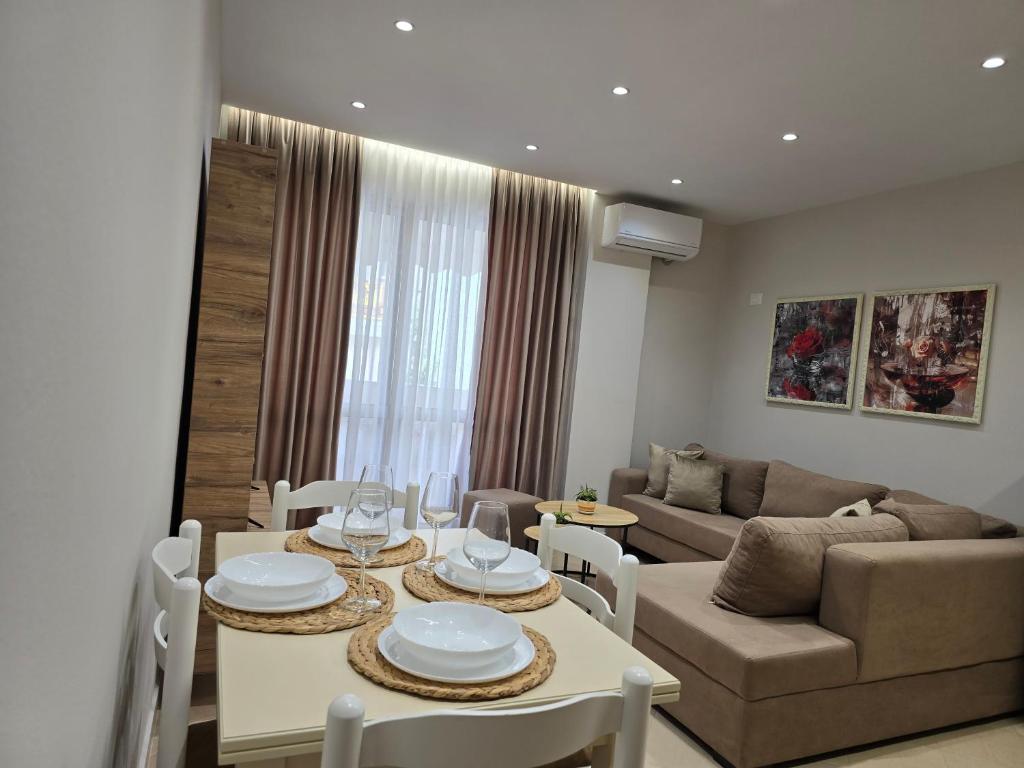 a living room with a table and a couch at A&B Seaside Residence in Golem