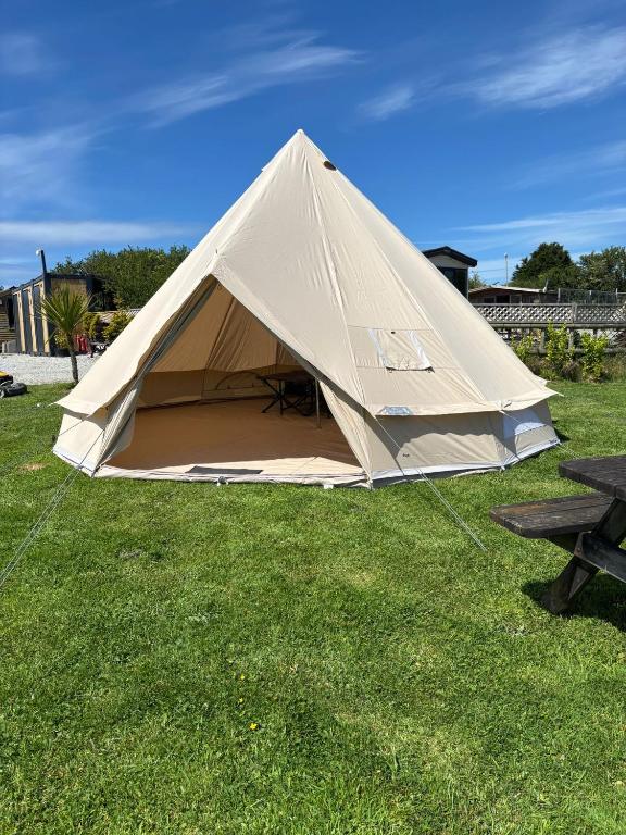 a large tent sitting on a field of grass at Cornwalls Glamping Tent in Delabole