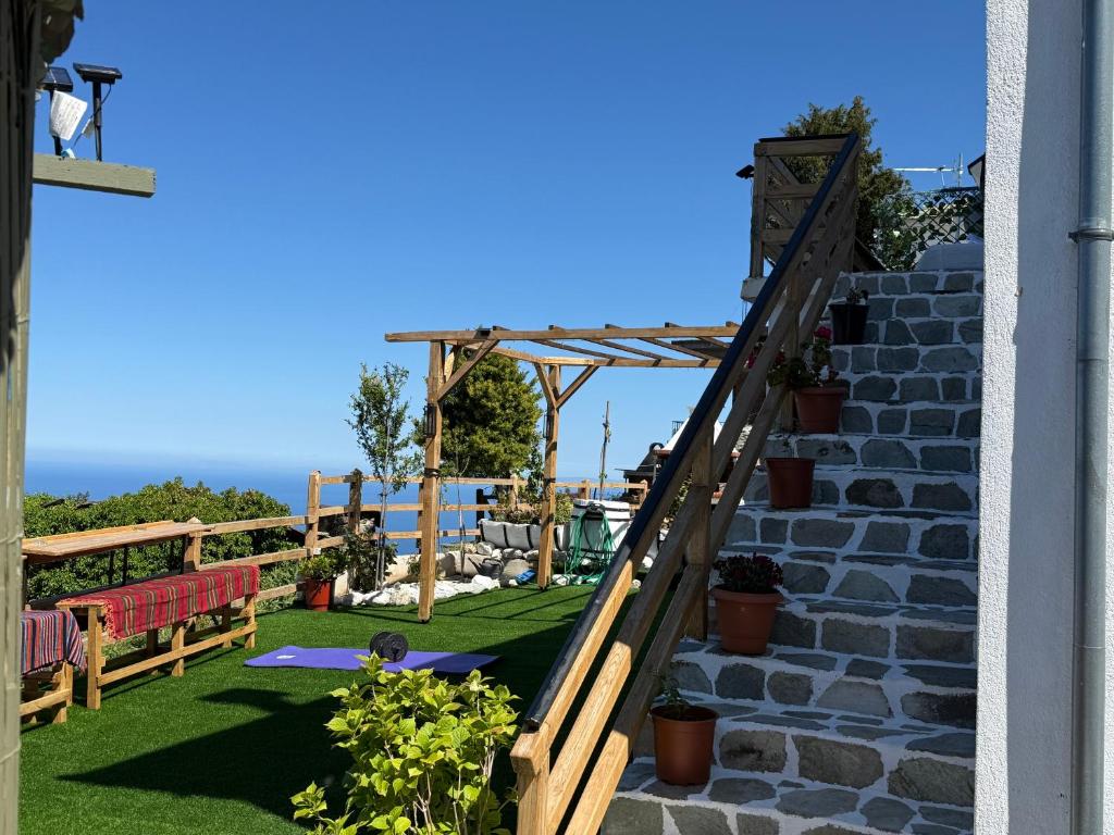 a set of stairs leading up to a patio with benches at Greek sensation in Zagora