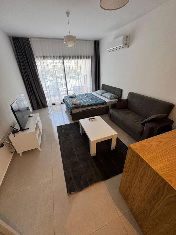 a living room with a couch and a table at Caesar Resort SPA in Iskele