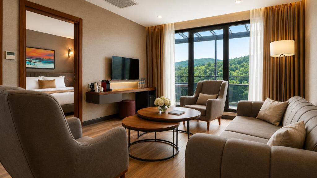 a hotel room with a couch and a bed at Hilas Thermal Resort Spa & Aquapark in Ladik
