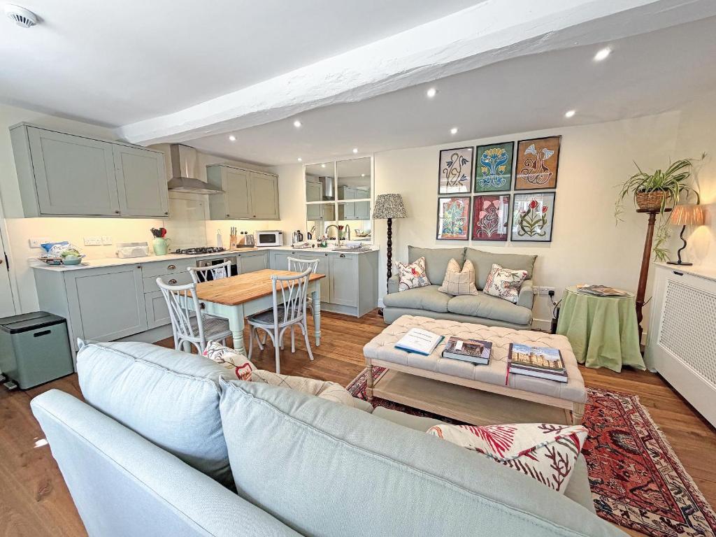 a living room with a couch and a table at Grange Cottage in Langham