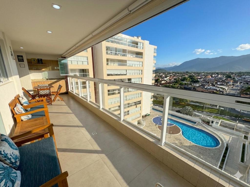 an apartment balcony with a view of a swimming pool at San Martin in Bertioga