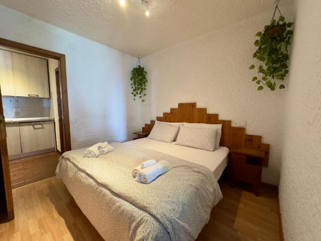 a bedroom with a bed with towels on it at Dimaro Apartment in Monclassico