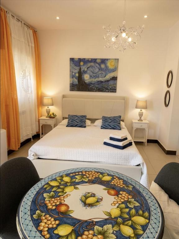 a room with a bed and a table with fruit on it at BlueSkyLite in Taormina