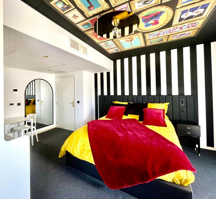a bedroom with a bed with a painting on the ceiling at Le Royal VIBES in Cap d'Agde