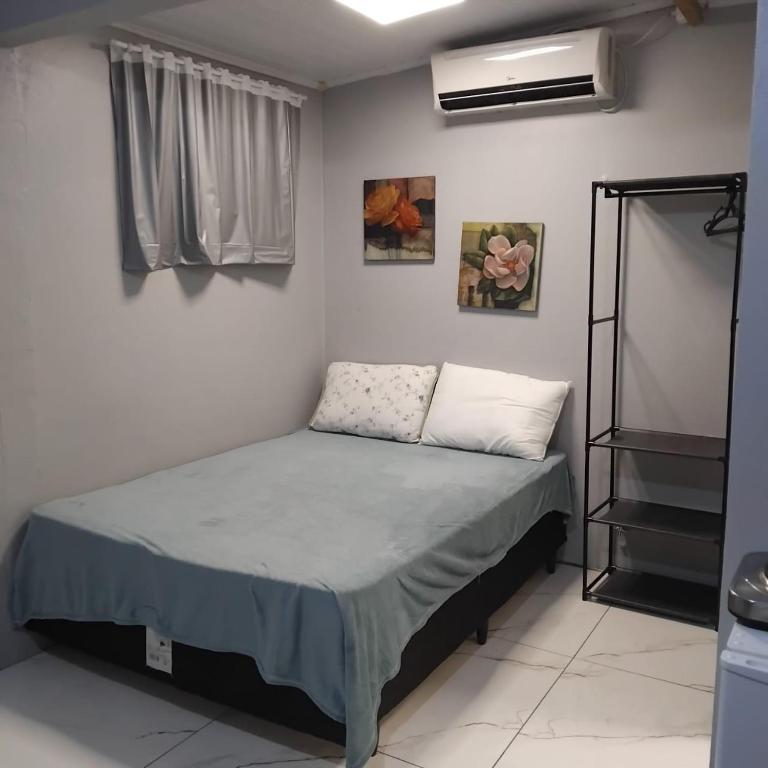 a bedroom with a bed in a room at Small and cozy in Ijuí