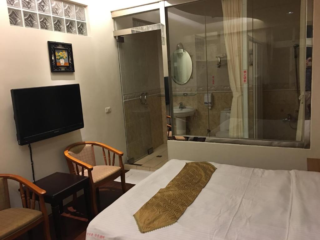 Postel nebo postele na pokoji v ubytování Ri Yue Hu Pan Resort