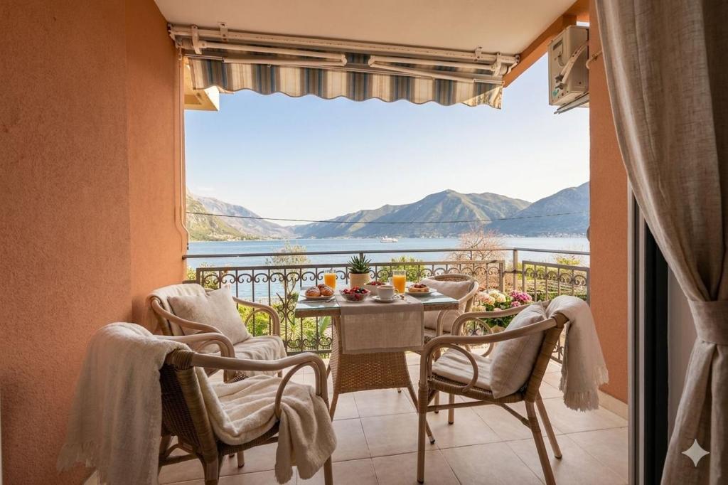 a balcony with a table and chairs and a view at Sea Nook in Trstenik