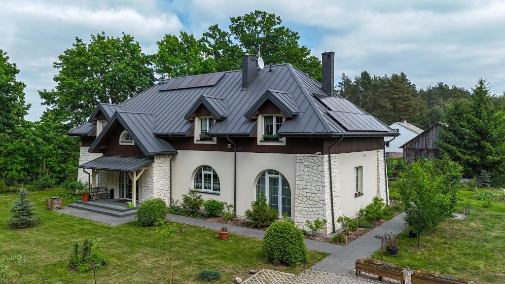 a house with a metal roof at Dworek Akacja in Janowiec