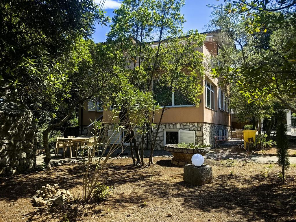 a house with a garden in front of it at Villa Mario Verde in Punat