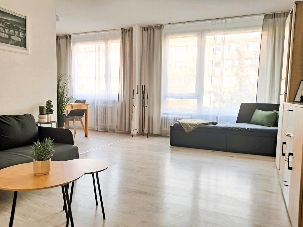 a living room with a couch and a table at Metro Budějovická apartment in Prague