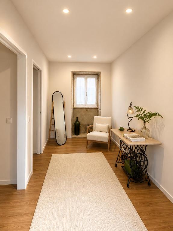 a living room with a mirror and a table at Casa da Linha in Caminha