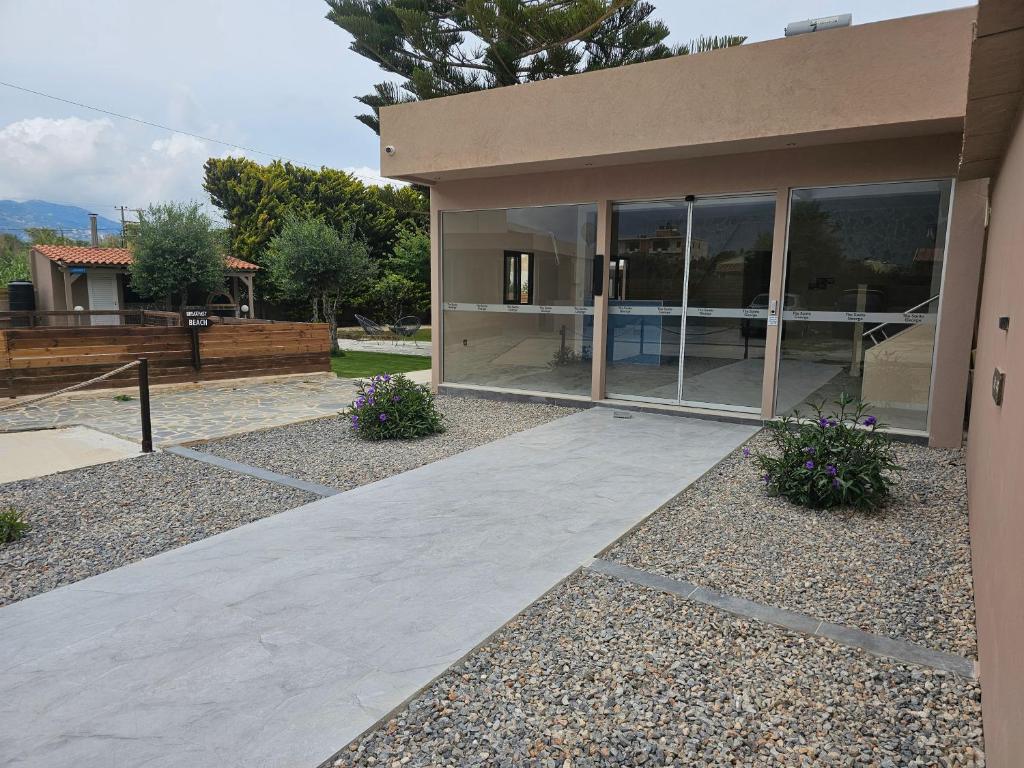 a house with a walkway in front of it at The Santo George Beach Resort in Amoudara Herakliou