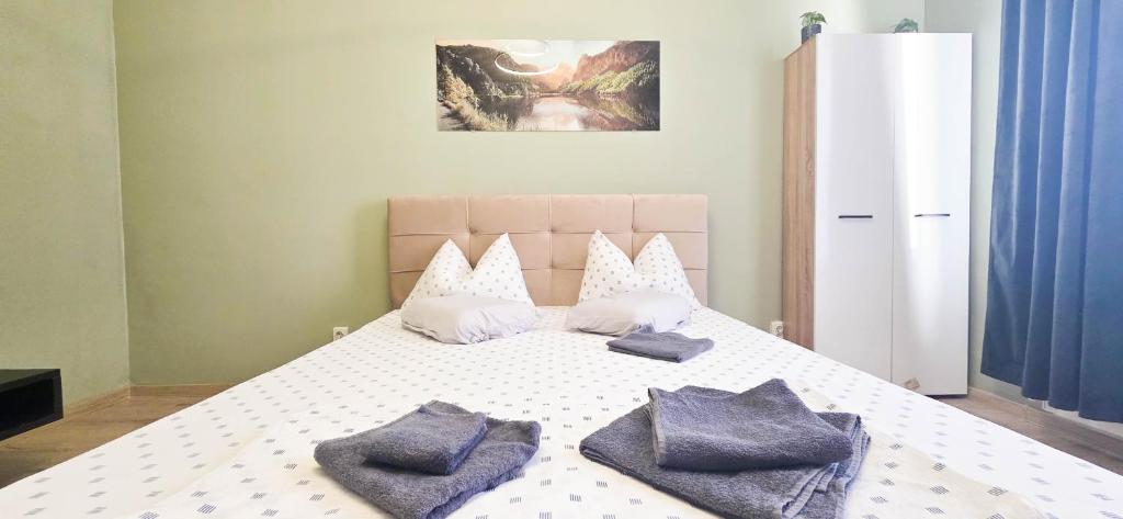 a bedroom with a bed with two pillows on it at Single room Perfect for single or couples! in Chiajna