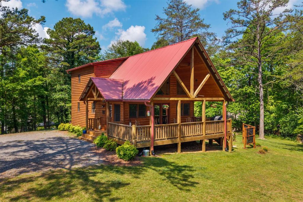 a log cabin with a red roof at Gentle Ben's Chalet in Murphy