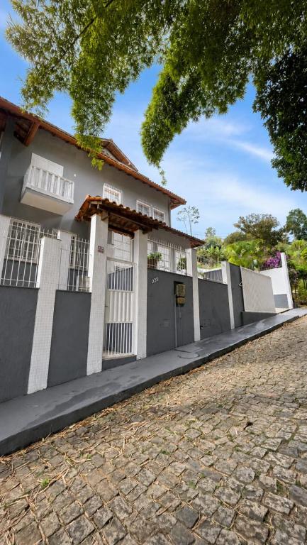 a house with a fence in front of it at Di Fronte Al Bosco in Santa Teresa
