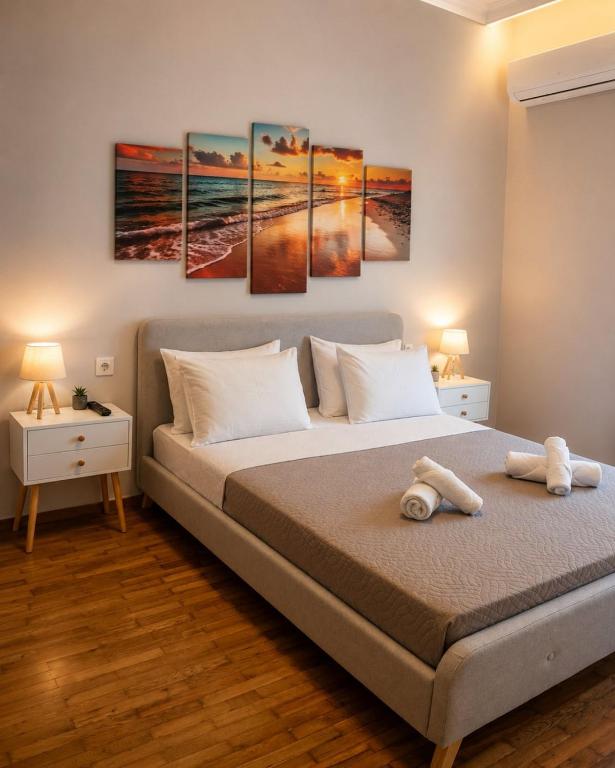 a bedroom with a bed with four paintings on it at GiAngels in Chania