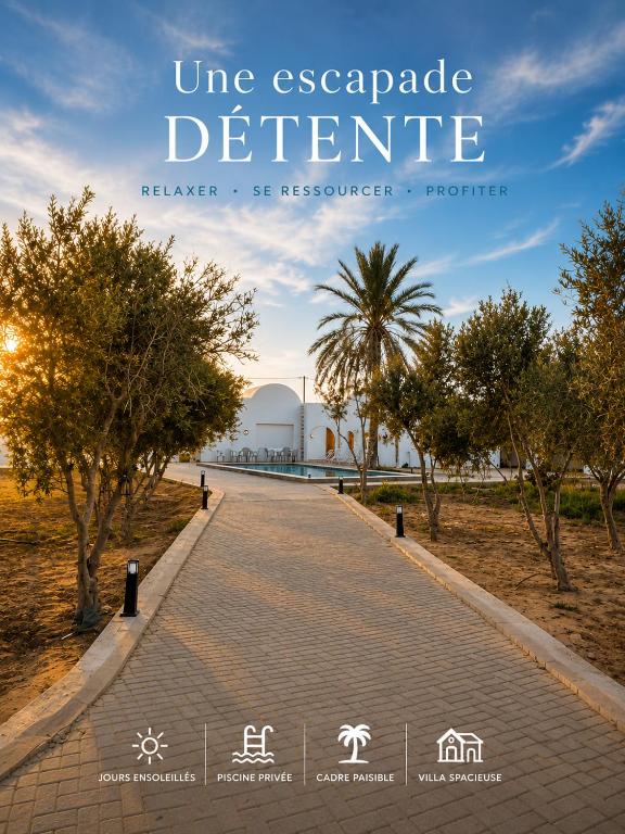a brick road in a park with a palm tree at Maison Ile d'Olive in Midoun
